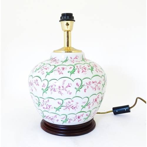 1418 - An Italian table lamp the ceramic body with pink and green floral and foliate detail. Approx. 15