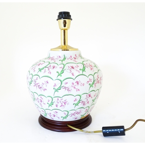 1418 - An Italian table lamp the ceramic body with pink and green floral and foliate detail. Approx. 15