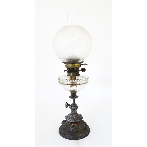 1421 - A Victorian oil lamp, the adjustable height cast base with clear glass reservoir with etched shade w... 