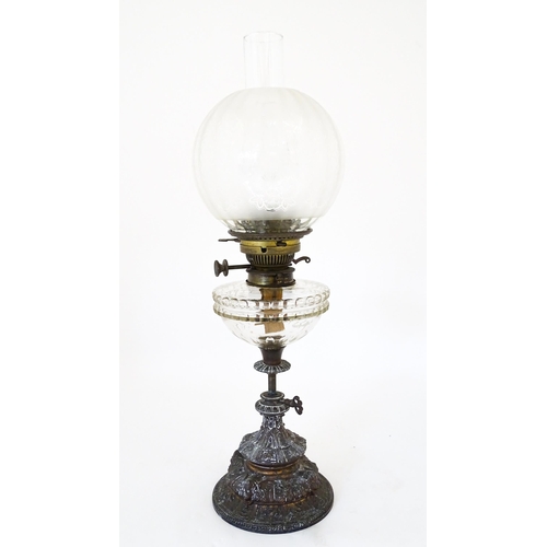 1421 - A Victorian oil lamp, the adjustable height cast base with clear glass reservoir with etched shade w... 