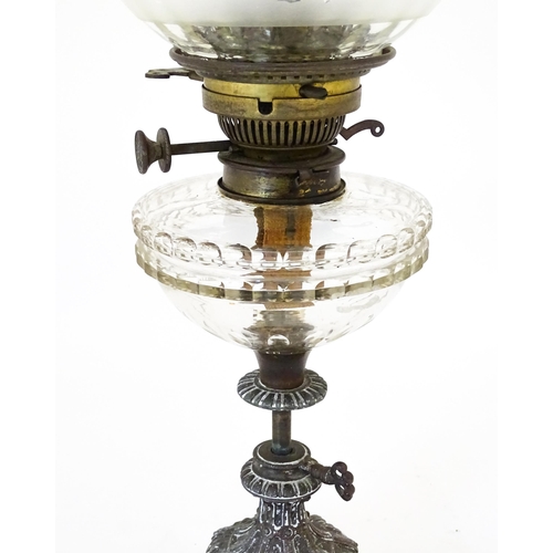 1421 - A Victorian oil lamp, the adjustable height cast base with clear glass reservoir with etched shade w... 