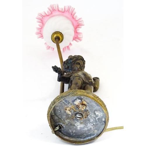 1422 - A mid 20thC table lamp the base of cast figural form, with a frilled pink and white shade. Approx. 1... 