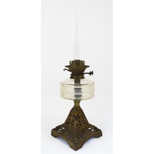 1425 - A late 19th / early 20thC oil lamp, the cast base with acanthus detail, having clear glass reservoir... 