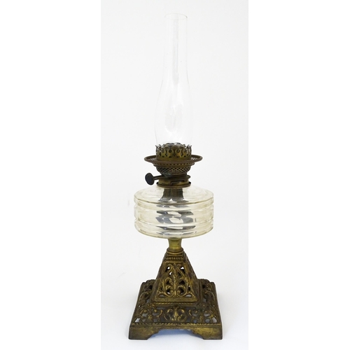 1425 - A late 19th / early 20thC oil lamp, the cast base with acanthus detail, having clear glass reservoir... 