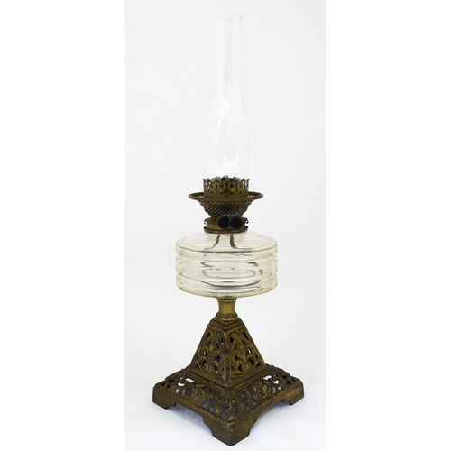 1425 - A late 19th / early 20thC oil lamp, the cast base with acanthus detail, having clear glass reservoir... 