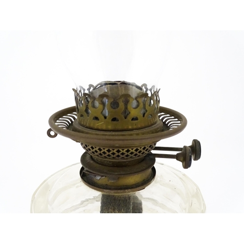 1425 - A late 19th / early 20thC oil lamp, the cast base with acanthus detail, having clear glass reservoir... 