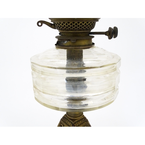 1425 - A late 19th / early 20thC oil lamp, the cast base with acanthus detail, having clear glass reservoir... 