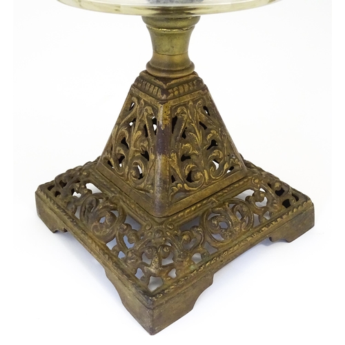 1425 - A late 19th / early 20thC oil lamp, the cast base with acanthus detail, having clear glass reservoir... 