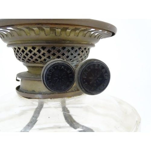 1425 - A late 19th / early 20thC oil lamp, the cast base with acanthus detail, having clear glass reservoir... 