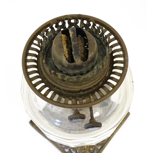 1425 - A late 19th / early 20thC oil lamp, the cast base with acanthus detail, having clear glass reservoir... 