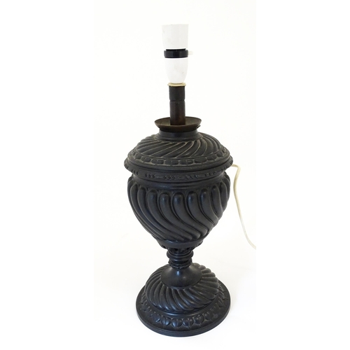 1426 - A 20thC cast table lamp of urn form. Approx. 18