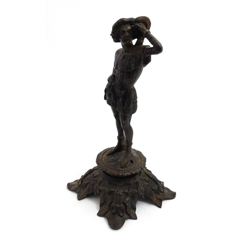 1002 - An early 20thC cast sculpture modelled as a young man, raised on an Art Nouveau base with foliate de... 