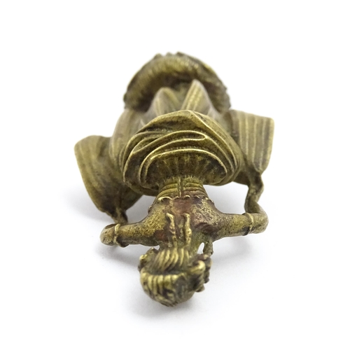 1010 - An Oriental cast model of a seated monkey, possibly a scroll weight. Together with a 20thC brass mat... 