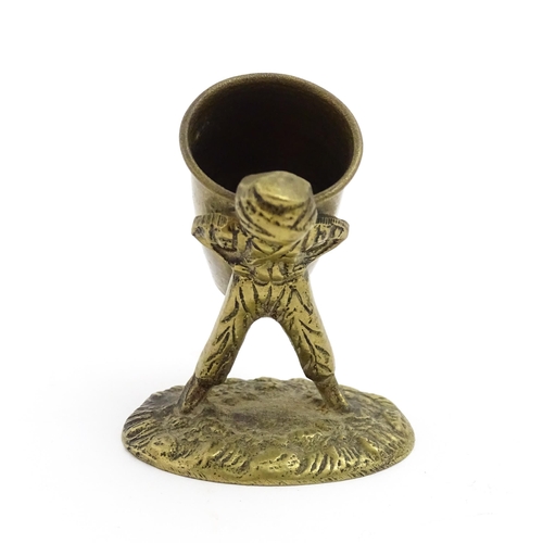 1010 - An Oriental cast model of a seated monkey, possibly a scroll weight. Together with a 20thC brass mat... 