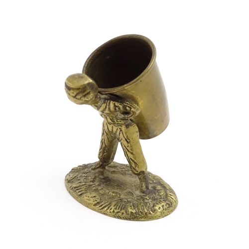 1010 - An Oriental cast model of a seated monkey, possibly a scroll weight. Together with a 20thC brass mat... 