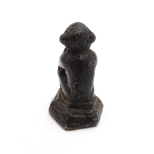 1010 - An Oriental cast model of a seated monkey, possibly a scroll weight. Together with a 20thC brass mat... 