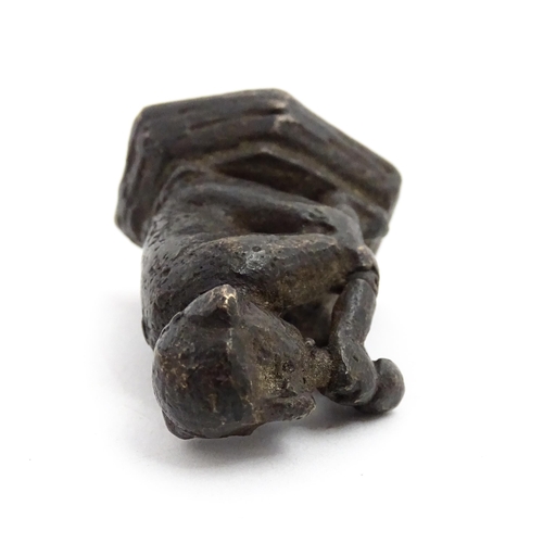 1010 - An Oriental cast model of a seated monkey, possibly a scroll weight. Together with a 20thC brass mat... 