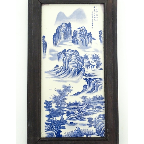 1027 - A Chinese blue and white transferware tile depicting a landscape scene with figures. Character marks... 