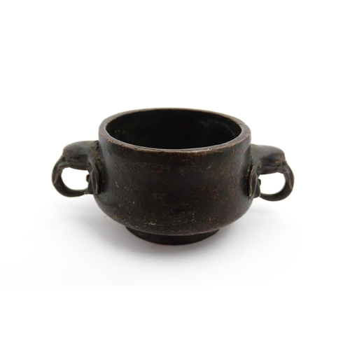 1036 - A small Chinese cast censer with twin elephant handles. Character mark to base. Approx. 3 1/4