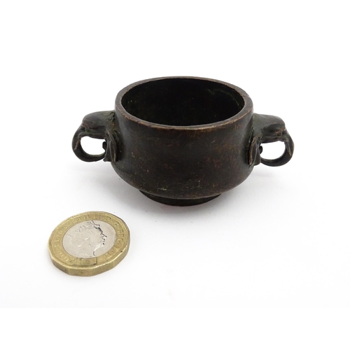 1036 - A small Chinese cast censer with twin elephant handles. Character mark to base. Approx. 3 1/4