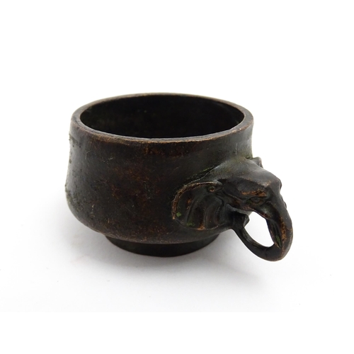 1036 - A small Chinese cast censer with twin elephant handles. Character mark to base. Approx. 3 1/4