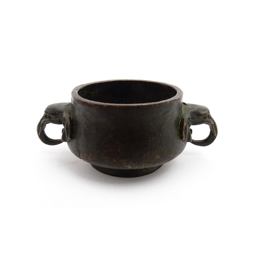 1036 - A small Chinese cast censer with twin elephant handles. Character mark to base. Approx. 3 1/4