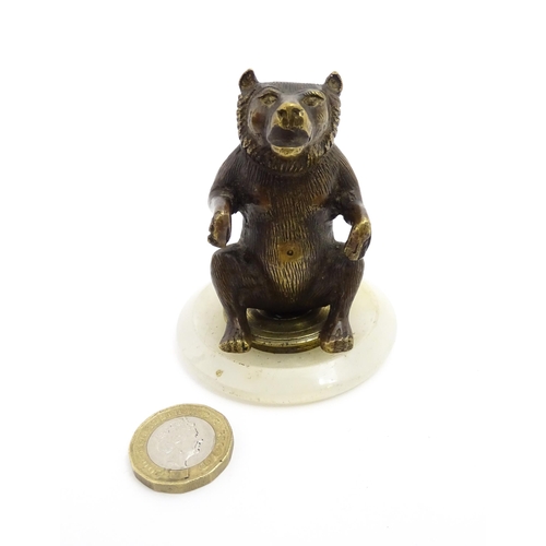 1051 - A 20thC gilt metal model of a seated bear. Approx. 2 3/4