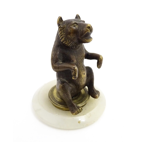 1051 - A 20thC gilt metal model of a seated bear. Approx. 2 3/4