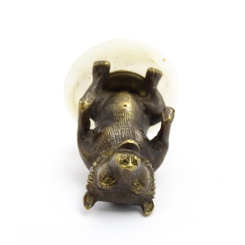 1051 - A 20thC gilt metal model of a seated bear. Approx. 2 3/4