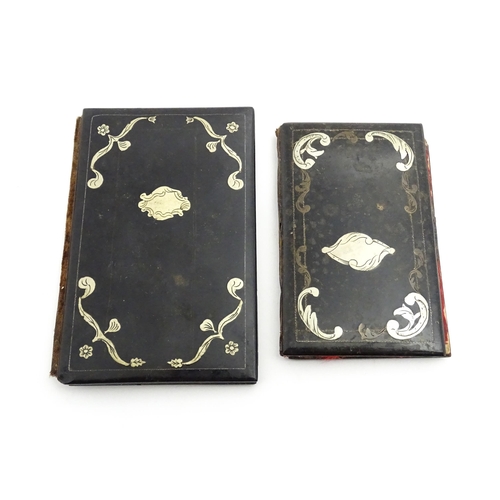 1061 - Two small 20thC Continental notebook covers with inlaid white metal detail. Largest approx. 3 3/4