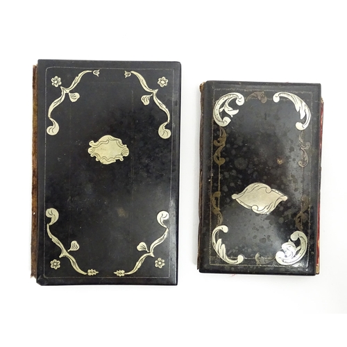 1061 - Two small 20thC Continental notebook covers with inlaid white metal detail. Largest approx. 3 3/4