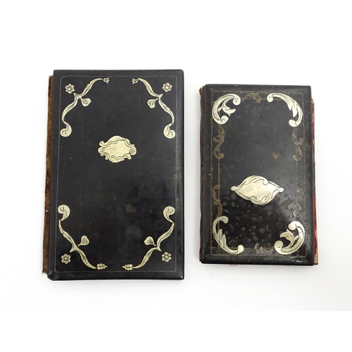 1061 - Two small 20thC Continental notebook covers with inlaid white metal detail. Largest approx. 3 3/4