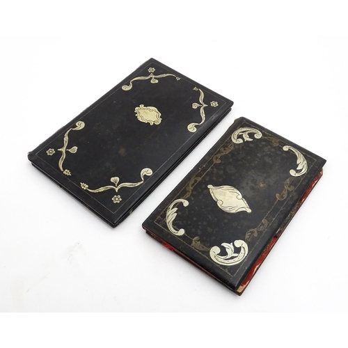 1061 - Two small 20thC Continental notebook covers with inlaid white metal detail. Largest approx. 3 3/4