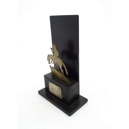 1085 - An early 20thC trophy depicting a Native American Indian on horseback on an ebonised base, bearing a... 