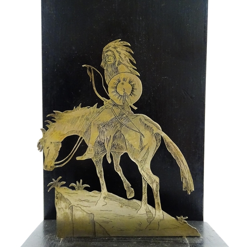 1085 - An early 20thC trophy depicting a Native American Indian on horseback on an ebonised base, bearing a... 