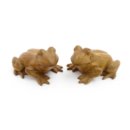 1134 - A pair of late 20thC carved wooden models of frogs / toads. Both signed Solomon under. Approx. 7