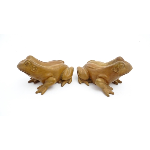 1134 - A pair of late 20thC carved wooden models of frogs / toads. Both signed Solomon under. Approx. 7