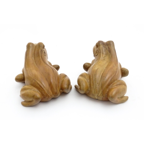 1134 - A pair of late 20thC carved wooden models of frogs / toads. Both signed Solomon under. Approx. 7