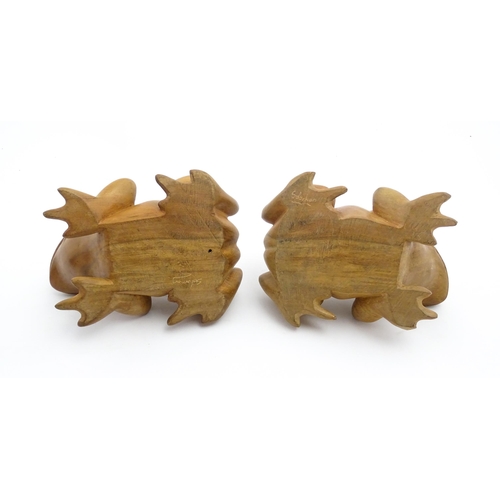 1134 - A pair of late 20thC carved wooden models of frogs / toads. Both signed Solomon under. Approx. 7