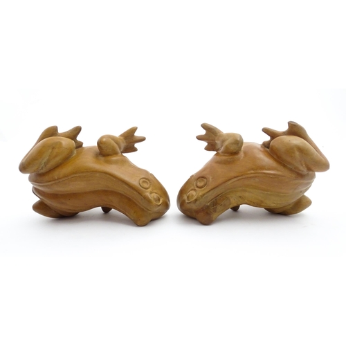 1134 - A pair of late 20thC carved wooden models of frogs / toads. Both signed Solomon under. Approx. 7