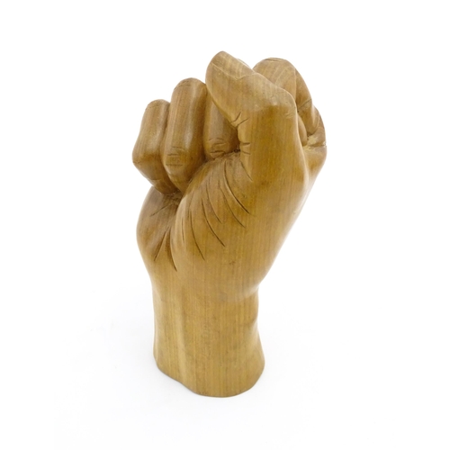 1135 - A late 20thC carved wooden model of a hand in a fist. Signed under Solomon. Approx. 6 1/2