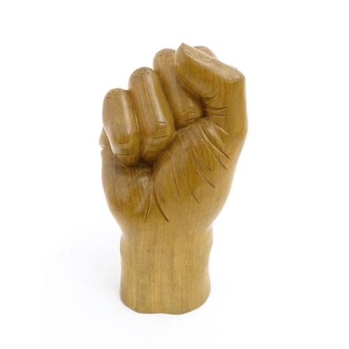 1135 - A late 20thC carved wooden model of a hand in a fist. Signed under Solomon. Approx. 6 1/2