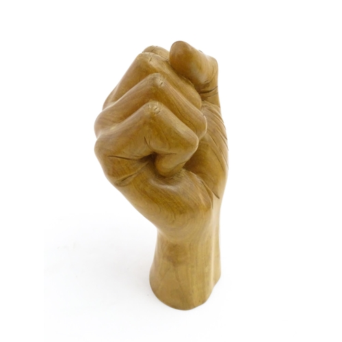 1135 - A late 20thC carved wooden model of a hand in a fist. Signed under Solomon. Approx. 6 1/2