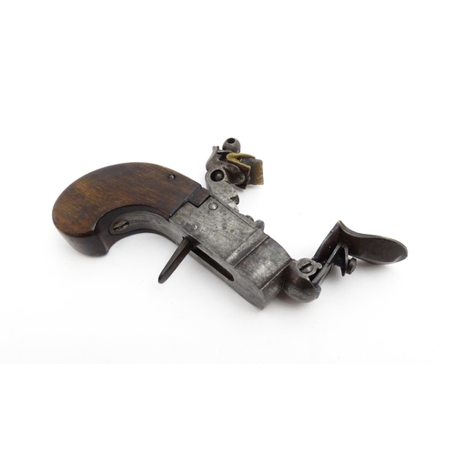 1195 - A 19thC tinder box lighter in the form of a flintlock pocket pistol, the lock with folding trigger, ... 