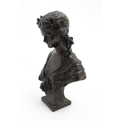 1226 - A 20thC cast bust of a young woman with flowers in her hair. Approx. 17 1/4