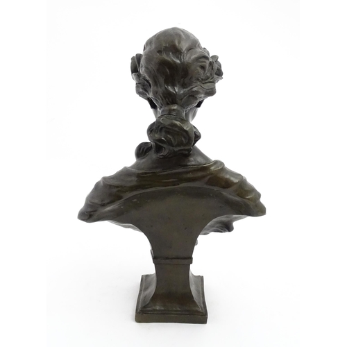 1226 - A 20thC cast bust of a young woman with flowers in her hair. Approx. 17 1/4