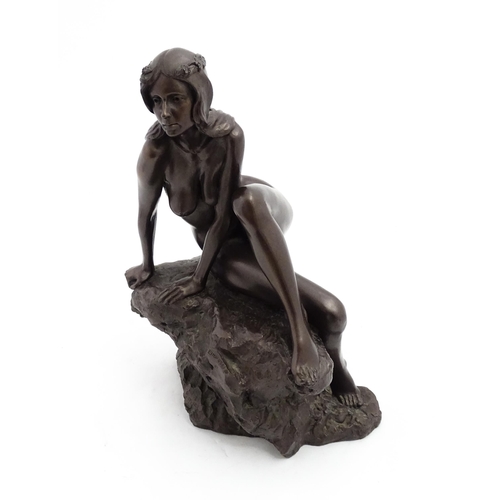 1242 - A 20thC bronzed resin sculpture after Brian Elton depicting a seated female nude on a rock. Bears ca... 