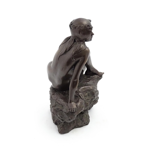 1242 - A 20thC bronzed resin sculpture after Brian Elton depicting a seated female nude on a rock. Bears ca... 