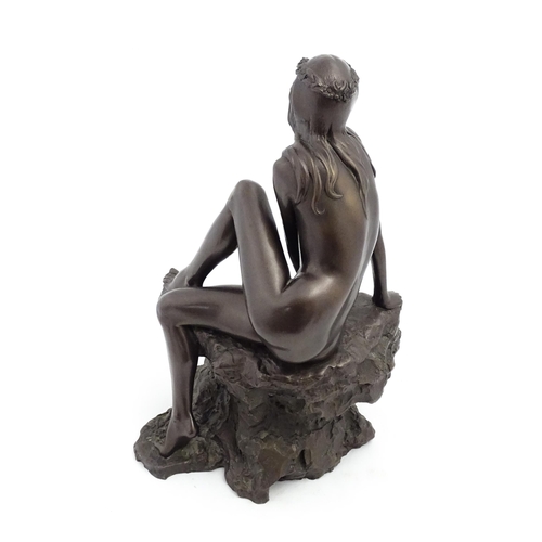 1242 - A 20thC bronzed resin sculpture after Brian Elton depicting a seated female nude on a rock. Bears ca... 