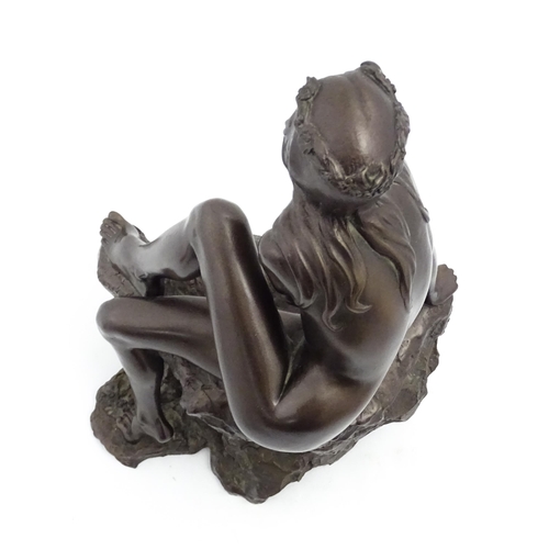 1242 - A 20thC bronzed resin sculpture after Brian Elton depicting a seated female nude on a rock. Bears ca... 